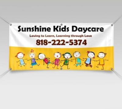 Full-color printed vinyl banner with grommets displayed at an event